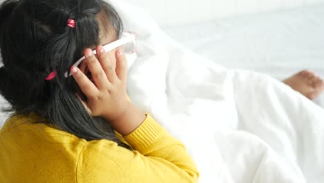 young girl covering her ears