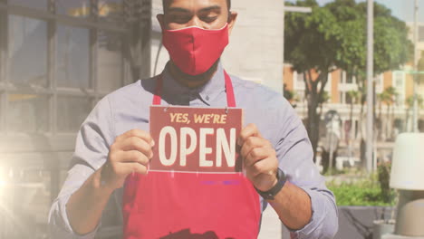 animation of digital interface over biracial man in face mask holding open sign