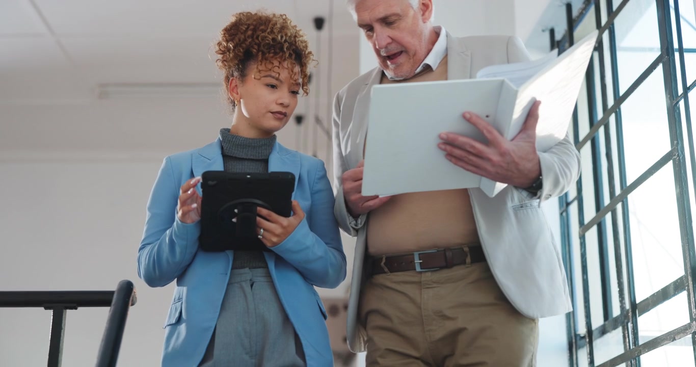 Business Professionals Discussing Documents in Modern Office