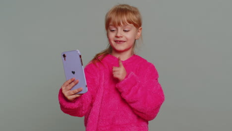 Child-girl-kid-blogger-taking-selfie-on-smartphone,-video-call-online,-recording-social-media-story