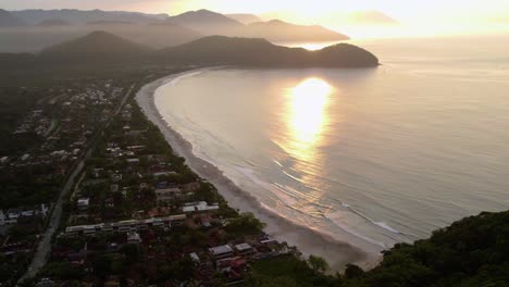 aerial overview of the praia da baleia beach, sunset in sao sebastiao, brazil