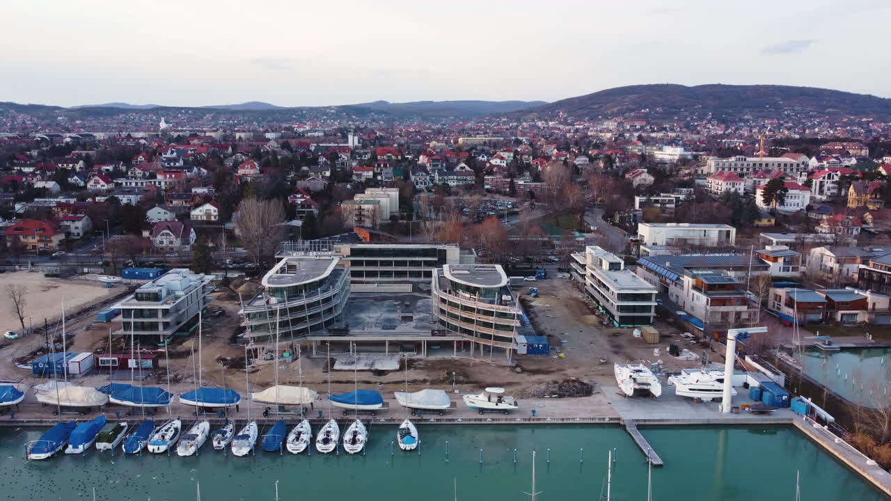 Aerial shot of Balatonfured town center and marina glowing in warm sunset light