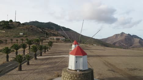 flying through blades of old wooden windmills on top of hill in porto santo