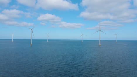 huge windmill turbines, offshore windmill farm in the ocean westermeerwind park , windmills isolated at sea on a beautiful bright day netherlands flevoland noordoostpolder