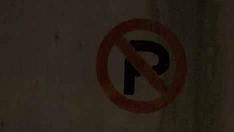Pan-right-to-a-parking-garage-pillar-with-the-"No-Parking"-symbol