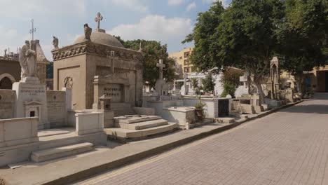 saint george cemetery in coptic cairo area, panning shot along stone graves, egypt