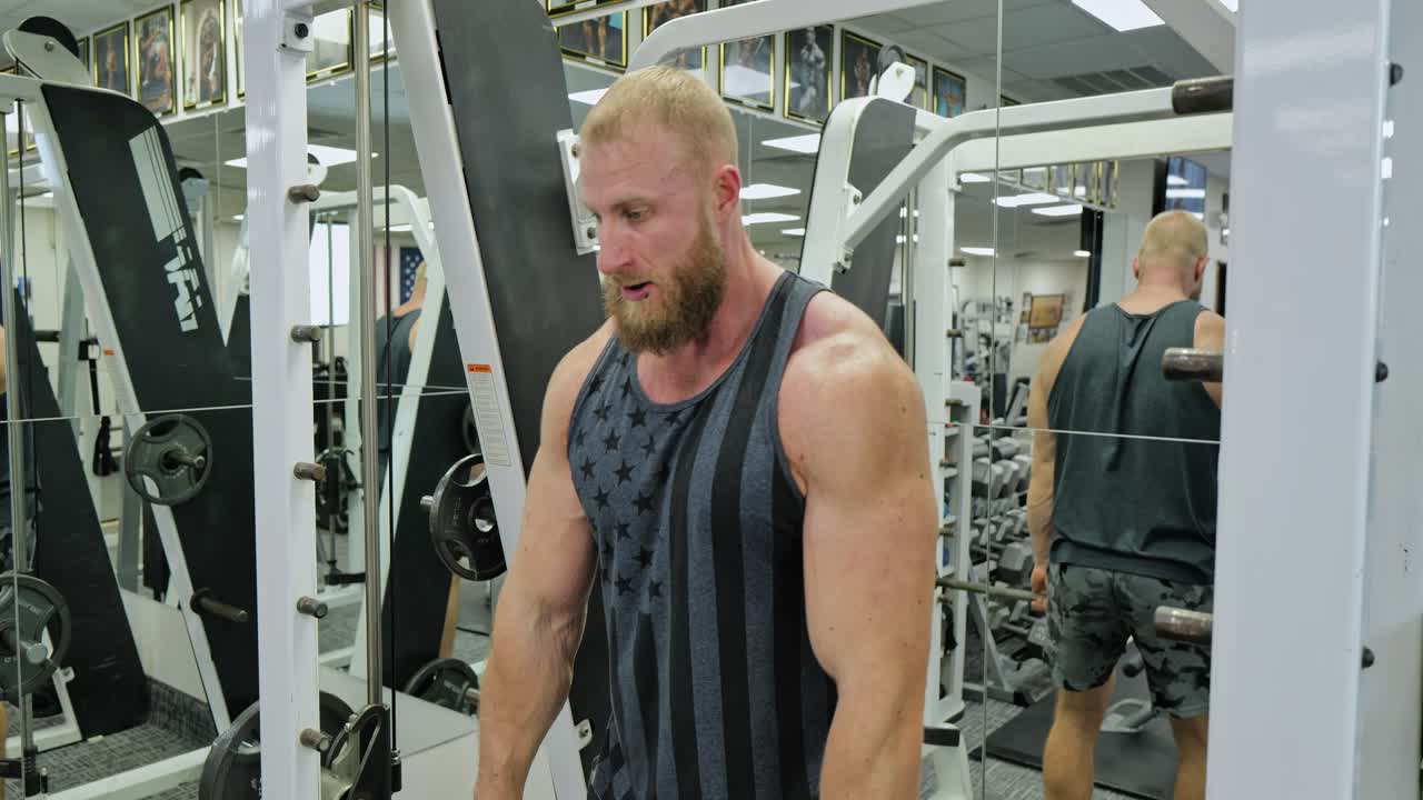 Strong bodybuilder lifting weights. Athletic person effort