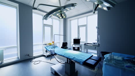 big light empty surgical room with few apparatuses prepared for operation. advanced equipment placed close to the operating table in the middle of the ward.