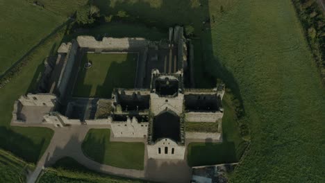 Aerial-view,-tilt-down,-Dunbrody-Abbey-is-a-former-Cistercian-monastery-in-County-Wexford,-Ireland