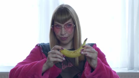 pink girl presenting a banana