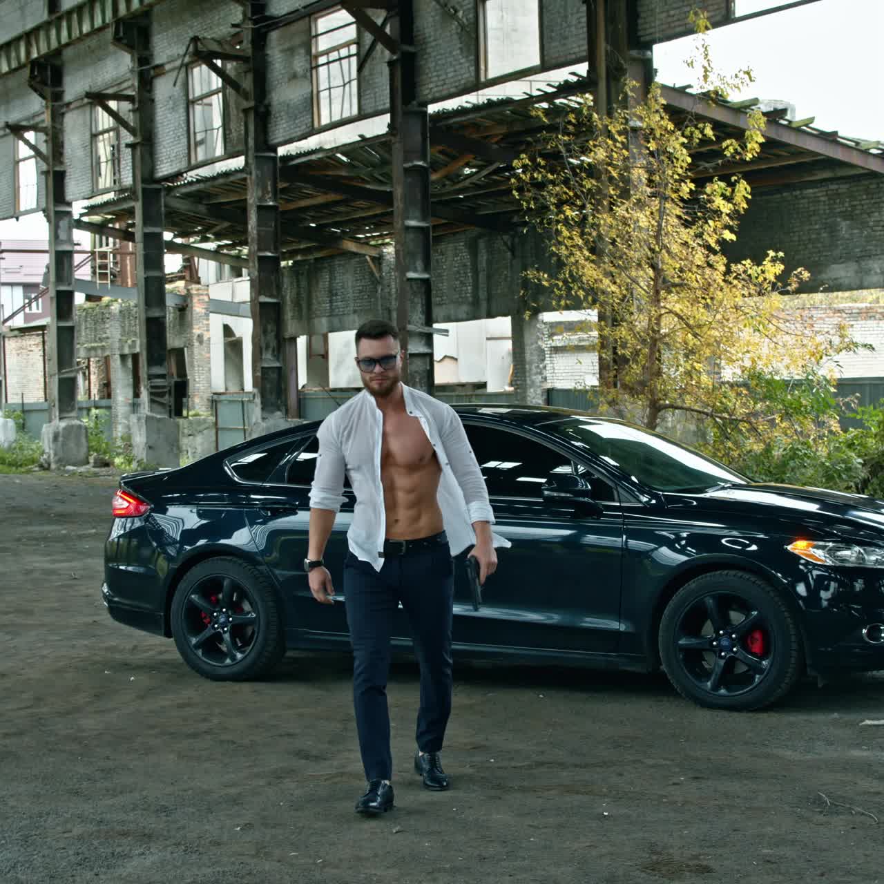 Young brutal man with gun