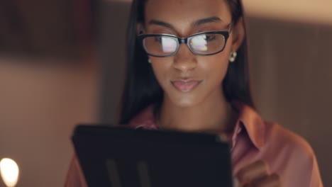 mujer de negocios leyendo tableta digital por la noche
