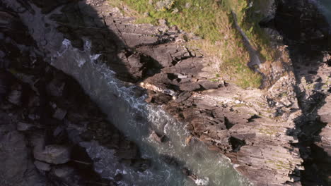 aerial flyover of rocky cove - headland from birds eye view