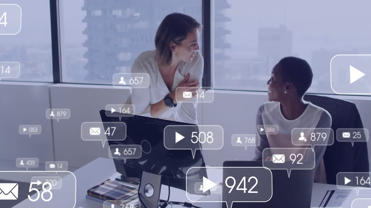Speaking to seated peer on laptop, colleague animating live marketing metrics for monitoring growth