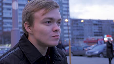 young man eating a burger in the city