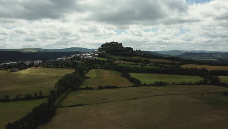 aerial view of a village with a castle on a hilltop
