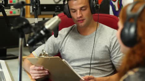 handsome student interviewing someone for radio in the studio