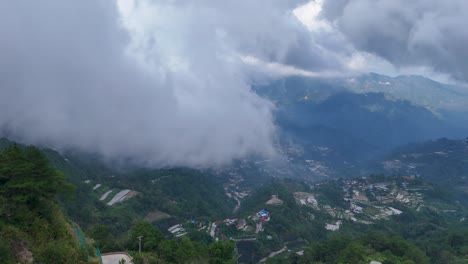 overcast mountain landscape with winding road and valley village