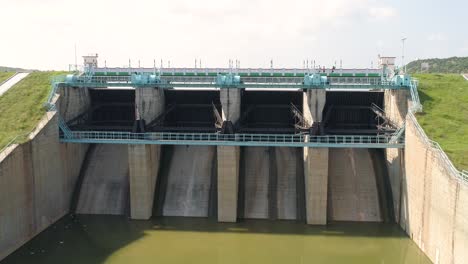 Zooming-Aerial-shot-a-closed-water-reservoir-gates-on-hot-summer-day-in-India