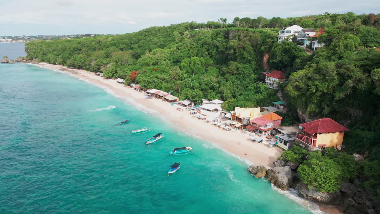 Aerial View of Stunning Tropical Beach with Turquoise Water and Lush Cliffside