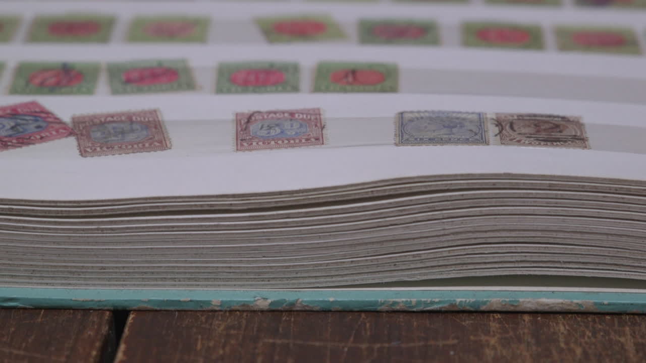 Pan over stamps in a stamp collectors album.