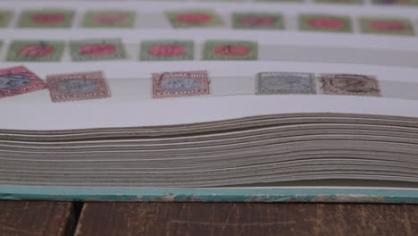 Pan over stamps in a stamp collectors album.