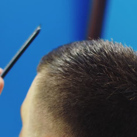 Close-Up-Of-Barber-Cutting-Client's-Hair