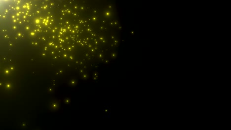 pequeñas partículas amarillas y estrellas en fondo oscuro