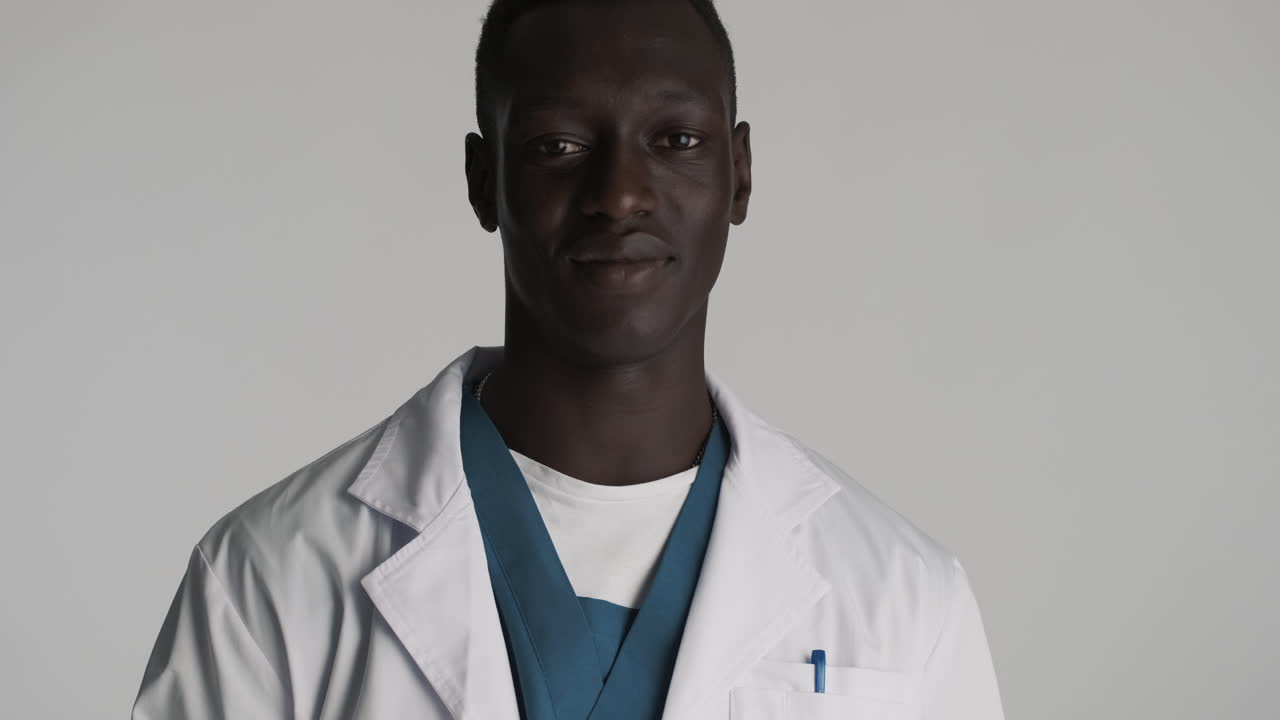 African american doctor on grey background.