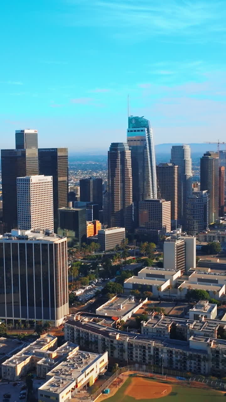 Skyscrapers in the downtown Los Angeles, California, USA. Beautiful modern architecture at backdrop of azure skies. Vertical video