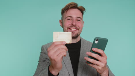 business man use credit bank card and smartphone while transferring money purchases online shopping