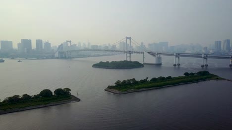 Aerial-view-of-rainbow-bridge-at-day-time-on-water-lowering