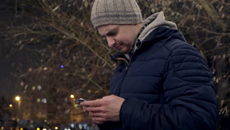 confused and angry man texting on a phone outdoors in a city