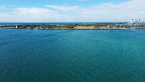 travelling fast over the water from wave break island to the gold coast seaway with the open parklands and city skylines in the distance