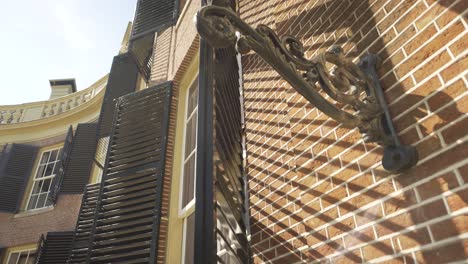 Window-and-lantern-in-Groeneveld-Castle-Utrecht,-low-angle-rotating-up-shot