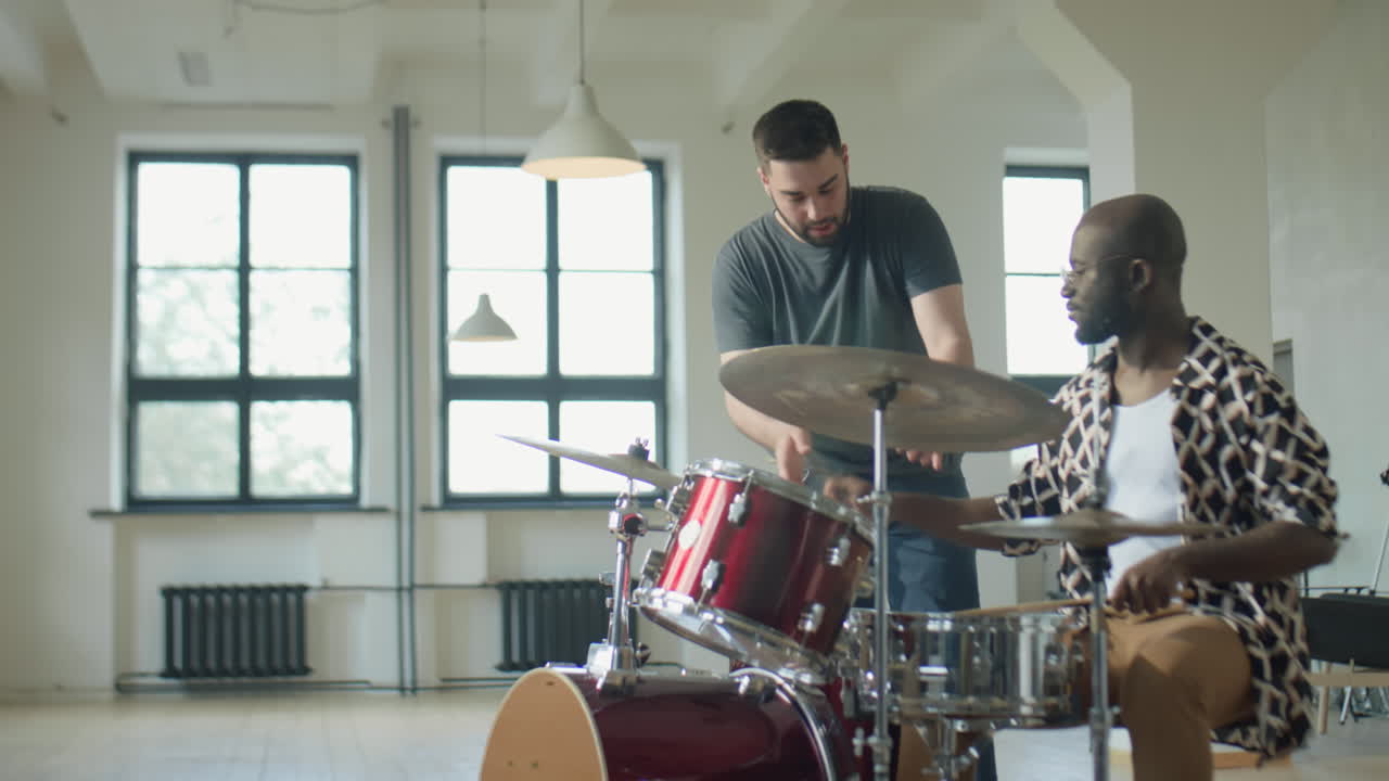 African American Man Learning Drums with Music Teacher