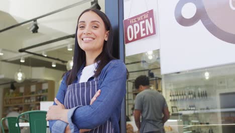 animation of happy biracial waitress standing in doors at coffee shop