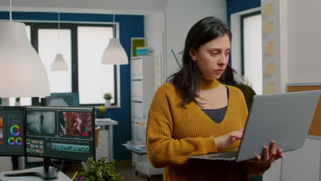 Woman-retoucher-looking-at-camera-smiling-working-in-creative-media-agency