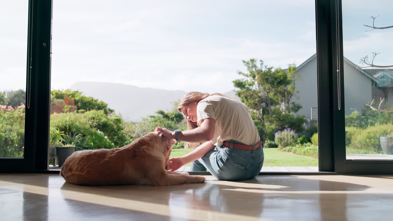 A woman petting a dog in a house