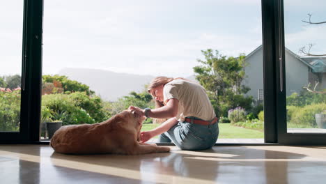 a woman petting a dog in a house