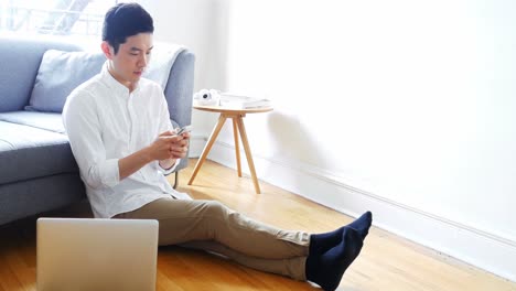 man using mobile phone in living room 4k