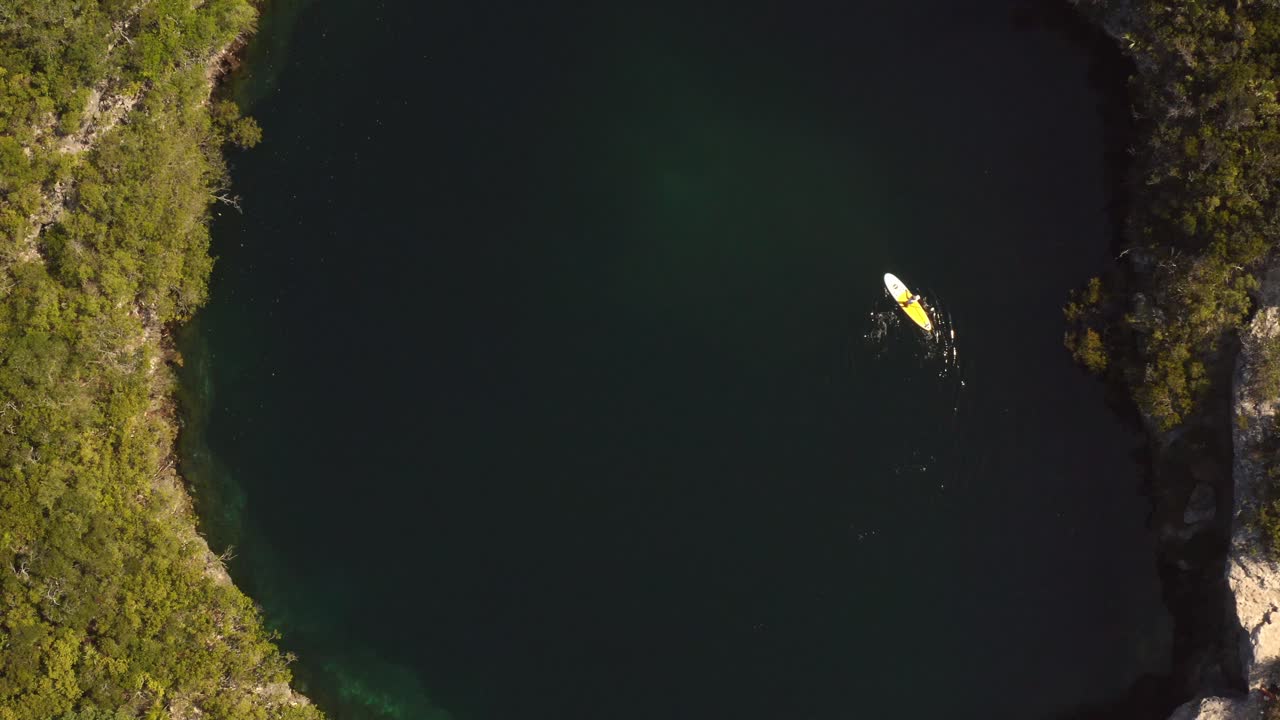 Kayaking in Blue Hole, Bahamas, Birdseye Aerial View. A Person in Kayak on Water Surface of Natural Wonder, Top Down Drone Shot