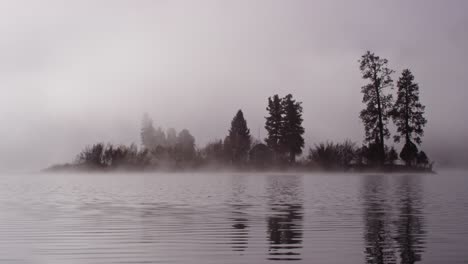 foggy dramatic scene looking across swan lake in montana