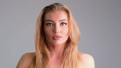 beautiful blonde girl looks up and stares into camera in slow motion beautiful blonde girl looks up and stares into camera in slow motion