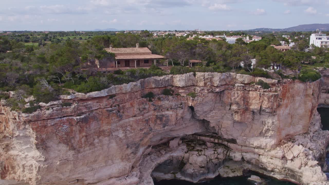 Old house on edge of cliff near Es Pont&agrave;s Mallorca Spain, aerial