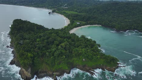 aerial flyover tropical headland with cliffs and surrounding sandy beaches, 4k costa rica caribbean