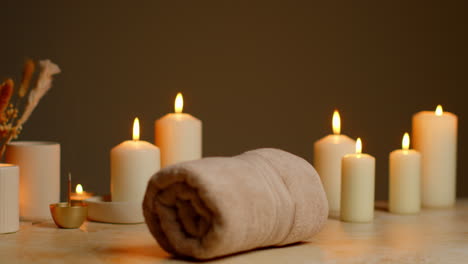 Still-Life-Of-Lit-Candles-With-Dried-Grasses-Incense-Stick-And-Soft-Towels-As-Part-Of-Relaxing-Spa-Day-Decor-9