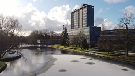 Pilkingtons-glass-head-quarters-blue-high-rise-business-office-park-aerial-dolly-left-view