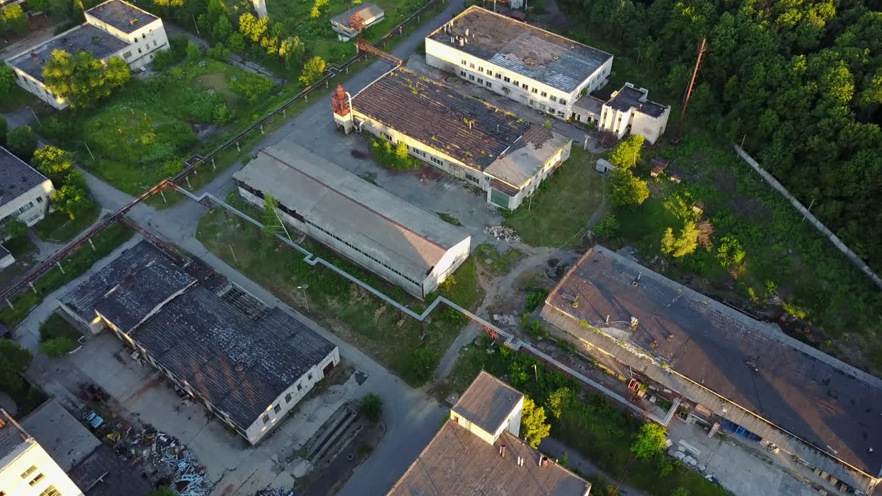 Abandoned Warehouses And Factories. Top view of the abandoned factory with broken windows and walls