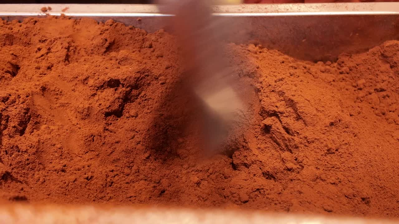 Close-Up of Hand Scooping Fresh Coffee Powder